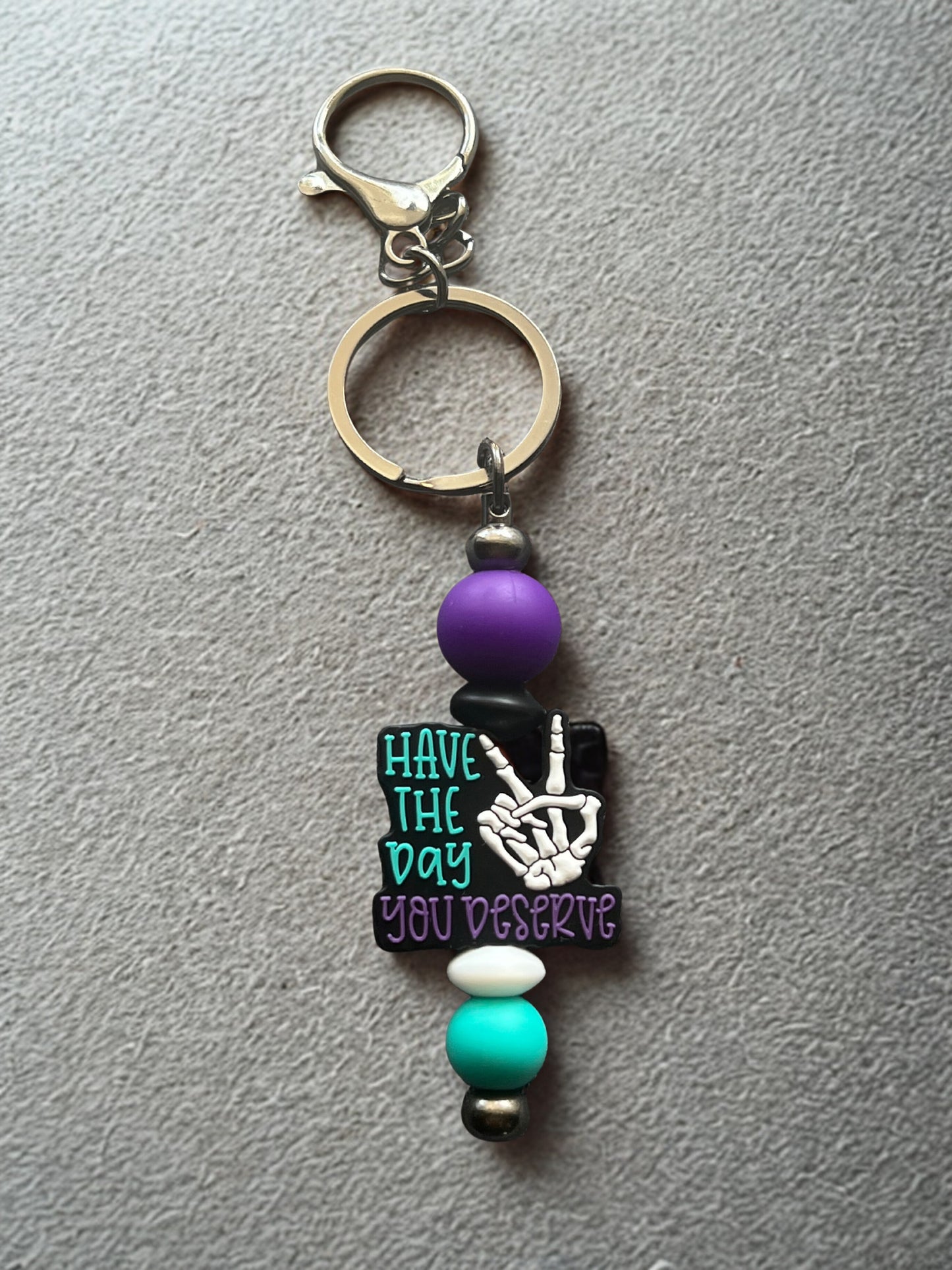 “Have The Day You Deserve” Keychain.